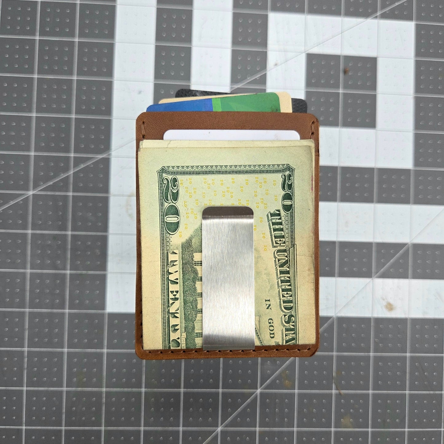 Money clip with cash on a grid background
